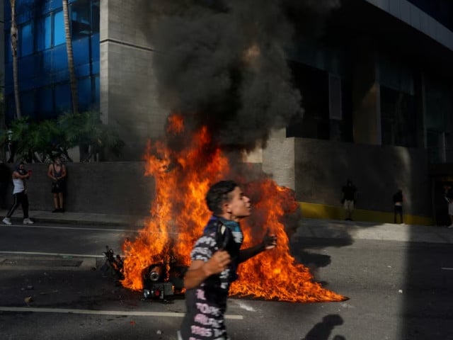 a police motorbike burns as people protest following the announcement by the national electoral council that venezuela s president nicolas maduro won the presidential election in caracas venezuela july 29 2024 photo reuters